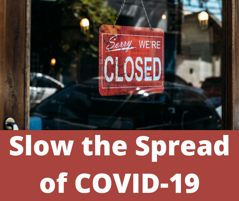 Sign in a shop window that reads, "Sorry, we're closed" and text saying, "Slow the Spread of Covid-19"