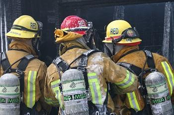 Firefighters looking away from camera