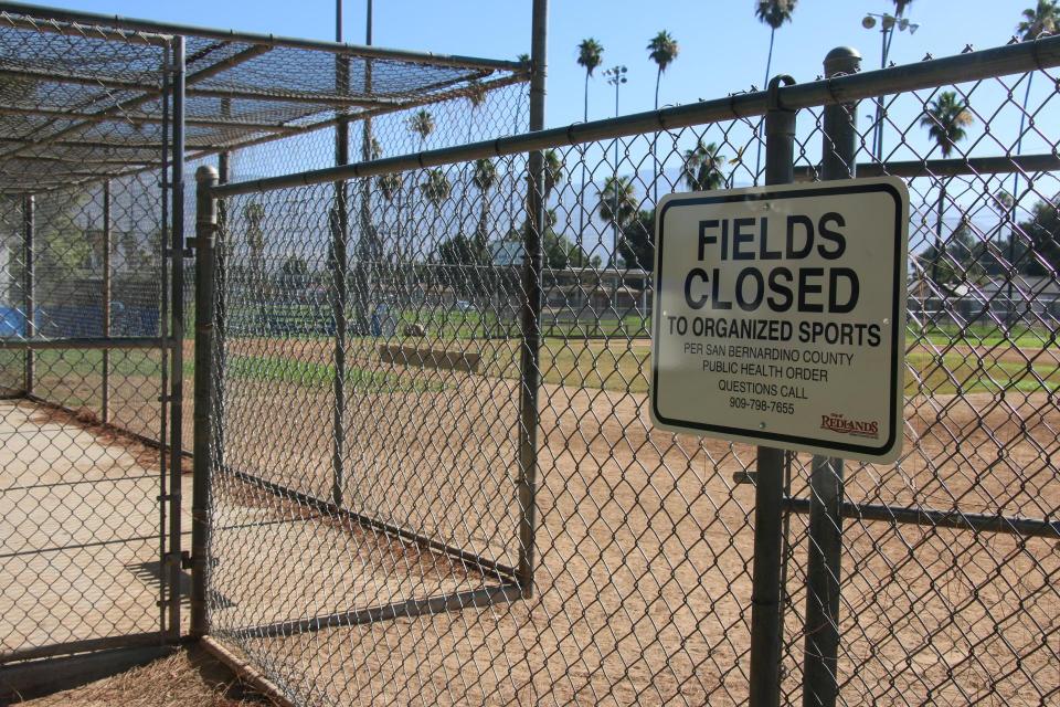 A sign at one of Community Field's baseball fields announces that the field is closed to organized sports.